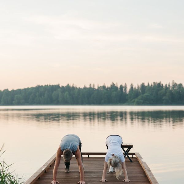 Person stretching outdoors during a beautiful sunrise.